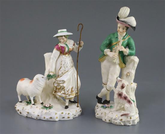 A pair of Rockingham porcelain groups of a shepherd and shepherdess, c.1830, h. 21.5 and 18cm, some faults